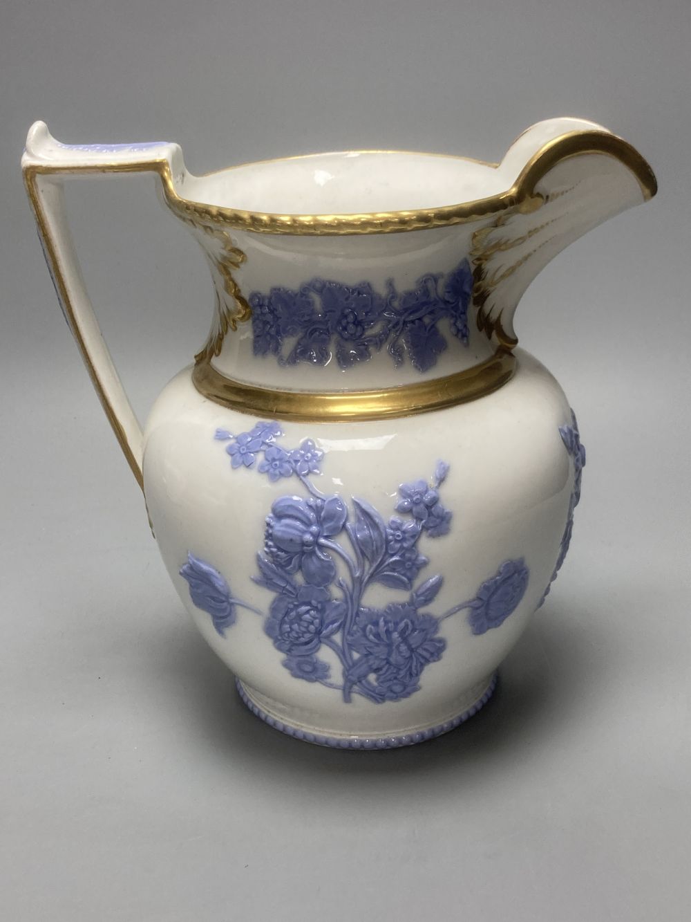 Four early 19th century Staffordshire jugs, each with lilac coloured floral applied panels, one dated 1826, tallest 22cm